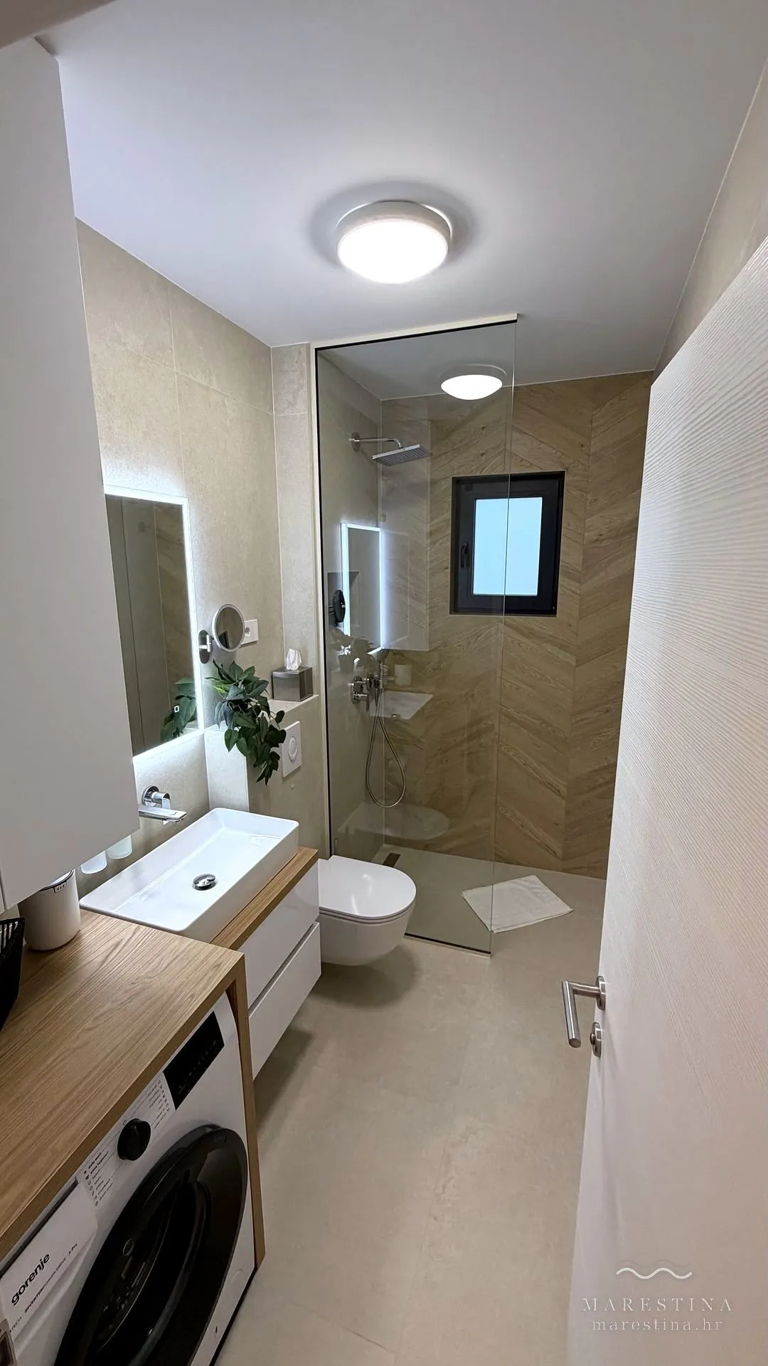 Second bathroom with walk-in shower and washing machine