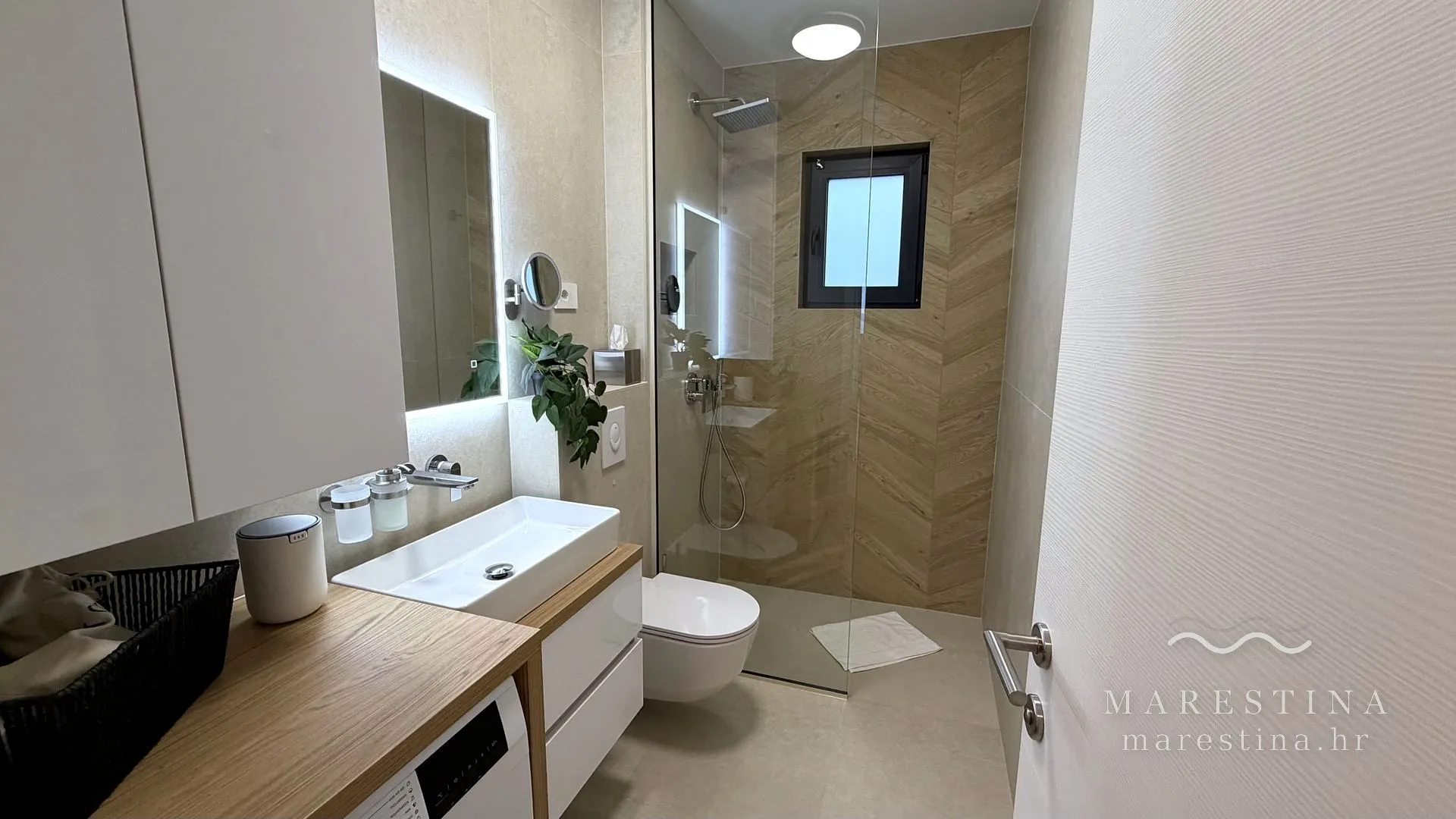 Second bathroom with walk-in shower and washing machine